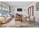 Living room boasts a neutral color palette, stylish furniture, and a wood coffee table at 10406 Lakeshore Dr, Clermont, FL 34711