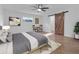 Main bedroom with ceiling fan and barn door at 10406 Lakeshore Dr, Clermont, FL 34711