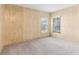 Simple bedroom with wood paneling, carpet, and window with blinds at 11 Orangewood Dr, Fruitland Park, FL 34731