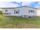 Side view of the home showcasing windows and AC unit at 11 Orangewood Dr, Fruitland Park, FL 34731