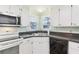 Kitchen with white cabinets, a double sink and dishwasher at 11 Orangewood Dr, Fruitland Park, FL 34731