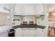 Breakfast bar with white cabinets and a view into the living area at 11 Orangewood Dr, Fruitland Park, FL 34731