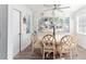 Bright dining room with round table and six chairs, looking toward living room at 1202 Granada Ct, The Villages, FL 32159