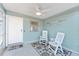 Cozy screened porch featuring white chairs and a floral patterned rug at 1202 Granada Ct, The Villages, FL 32159