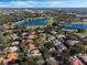 Bird's-eye view of lakefront homes in a golf course community at 1286 Prince Ct, Lake Mary, FL 32746