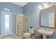 Bathroom with light blue walls and a walk-in shower at 1286 Prince Ct, Lake Mary, FL 32746