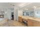 Double vanity bathroom with a large mirror and built-in shelving at 1286 Prince Ct, Lake Mary, FL 32746