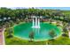 Aerial view of a circular pond with a fountain in the center at 1286 Prince Ct, Lake Mary, FL 32746