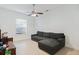 Living room with grey sectional sofa and ceiling fan at 1286 Prince Ct, Lake Mary, FL 32746