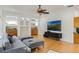 Bright living room with hardwood floors, comfy seating, and built-in shelving at 1286 Prince Ct, Lake Mary, FL 32746