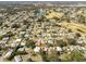 Aerial of home in community near golf course and lake at 1404 Torrey Pines Dr, The Villages, FL 32159
