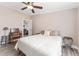 Spacious bedroom with a desk and chair, featuring a ceiling fan at 1404 Torrey Pines Dr, The Villages, FL 32159