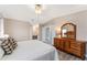 Main bedroom with dresser, bench, and ceiling fan at 1404 Torrey Pines Dr, The Villages, FL 32159