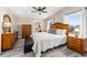 Main bedroom with wood furniture, and a view of the backyard at 1404 Torrey Pines Dr, The Villages, FL 32159