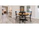 Cozy dining area with round table and four chairs, near the kitchen at 1404 Torrey Pines Dr, The Villages, FL 32159