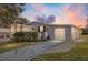 Updated manufactured home with a gray exterior, new landscaping, and a paved driveway at 1404 Torrey Pines Dr, The Villages, FL 32159