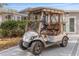 Nice golf cart parked outside the home at 1404 Torrey Pines Dr, The Villages, FL 32159