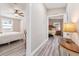 Bright hallway with light flooring, offering views into bedrooms at 1404 Torrey Pines Dr, The Villages, FL 32159