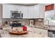 Kitchen island with granite countertop, perfect for casual dining at 1404 Torrey Pines Dr, The Villages, FL 32159
