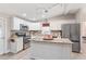 Modern kitchen with granite countertops, stainless steel appliances, and an island at 1404 Torrey Pines Dr, The Villages, FL 32159
