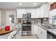 Bright kitchen with granite countertops and stainless steel appliances at 1404 Torrey Pines Dr, The Villages, FL 32159