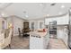 Open kitchen with granite island, stainless steel appliances and breakfast nook at 1404 Torrey Pines Dr, The Villages, FL 32159