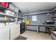 Well-equipped laundry room with washer, dryer, and ample storage shelves at 1404 Torrey Pines Dr, The Villages, FL 32159