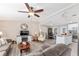 Open living room with gray sofas, a coffee table, and hardwood-look floors at 1404 Torrey Pines Dr, The Villages, FL 32159