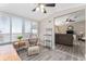 Bright sunroom features a wood-look floor, wooden furniture, and large windows at 1404 Torrey Pines Dr, The Villages, FL 32159