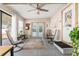 Relaxing sunroom with French doors, ceiling fan, and comfortable seating at 1404 Torrey Pines Dr, The Villages, FL 32159