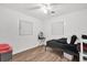 Bedroom with black bedding, ceiling fan, and wood-look floors at 1412 N Garfield Ave, Deland, FL 32724