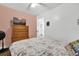 Bedroom with floral bedding, dresser, and view of kitchen at 1412 N Garfield Ave, Deland, FL 32724