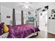Purple-accented bedroom with wall art and a view into another room at 1412 N Garfield Ave, Deland, FL 32724