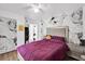 Bedroom with purple comforter and floral wall mural at 1412 N Garfield Ave, Deland, FL 32724