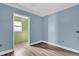 Small bedroom with light blue walls and wood-look floors at 1412 N Garfield Ave, Deland, FL 32724