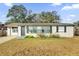 One-story house with a large front yard and driveway at 1412 N Garfield Ave, Deland, FL 32724