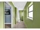 Green hallway with wood-look floors and access to other rooms at 1412 N Garfield Ave, Deland, FL 32724