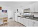 White kitchen cabinets, granite countertops, and a small breakfast nook at 1412 N Garfield Ave, Deland, FL 32724