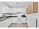 White kitchen cabinets, granite countertops, and white appliances at 1412 N Garfield Ave, Deland, FL 32724