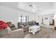 Living room with gray sofas, white coffee table, and wood-look flooring at 1412 N Garfield Ave, Deland, FL 32724