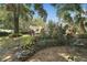 Landscaped backyard with stone wall and shed at 163 N Clayton St, Mount Dora, FL 32757