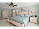 Spacious bedroom with large bed, dresser, and ensuite bathroom access at 163 N Clayton St, Mount Dora, FL 32757