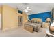 Spacious main bedroom with a king-size bed and blue accent wall at 16679 Se 77Th Northridge Ct, The Villages, FL 32162