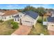 Two-story house with tan exterior, gray roof and brick driveway at 16792 Meadows St, Clermont, FL 34714