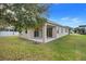 Home with covered patio and grassy backyard at 16792 Meadows St, Clermont, FL 34714