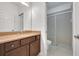 Bathroom with dark vanity, granite countertop and shower at 16792 Meadows St, Clermont, FL 34714