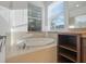 Bathroom with garden tub and large window at 16792 Meadows St, Clermont, FL 34714