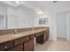 Double vanity bathroom with granite countertop and tile flooring at 16792 Meadows St, Clermont, FL 34714