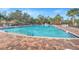Community pool with lounge chairs and picnic tables at 16792 Meadows St, Clermont, FL 34714