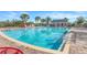 Community pool with lounge chairs and a pool house at 16792 Meadows St, Clermont, FL 34714
